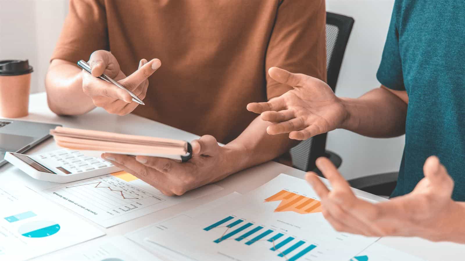 Business owner and consultant discussing financial charts at a fractional CFO meeting
